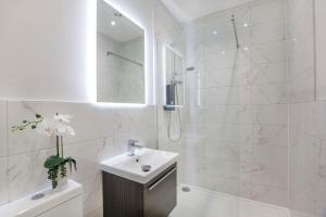 a white bathroom with a sink and a shower at York Luxury Apartments, Bishopthorpe Rd in York +45 photos