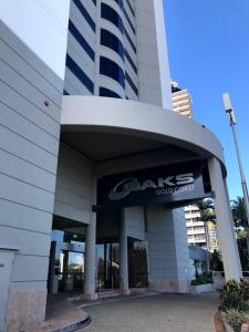 a building with a sign on the front of it at Luxury Ocean View Studio Apartments in Gold Coast