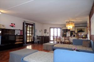 a living room with couches and a dining room at Villetta Mazzini Front Lake - Happy Rentals in Peschiera del Garda