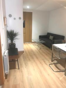 a living room with a couch and a table at Alos Apartments Paseo de Gracia-Diagonal in Barcelona