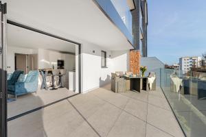 a balcony with a view of a living room and dining room at Estuary View, 3 Grand Banks in Teignmouth