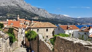 a view of a town with a mountain in the background at Apartments Morning Sunshine in Korčula