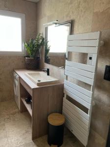 a bathroom with a sink and a mirror at La Granja - Maison avec cheminée, jardin, baby-foot in Formiguères +7 photos