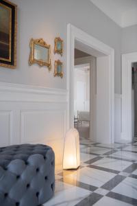 a white room with a black and white checkered floor at Villa Luce Assisi Rooms & Suites in Santa Maria degli Angeli