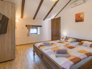 a large bedroom with a large bed with pillows on it at Villa Histria - Adriatic Luxury Villas in Manjadvorci +38 photos