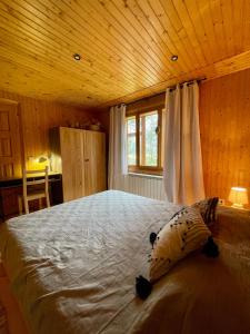 a bedroom with a large bed with a wooden ceiling at Sheshory Chalet in Sheshory
