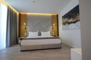 a bedroom with a king sized bed in a room at EBBI HOTEL in Dhërmi +55 photos
