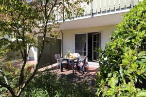 a patio with a table and chairs on a house at Altes Wasserwerk App 02 in Wustrow