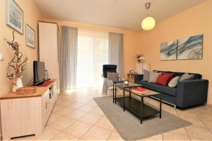 a living room with a couch and a tv at Altes Wasserwerk App 02 in Wustrow