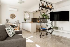 a living room with a couch and a tv at Diov Bohali House in Zakynthos Town