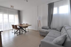 a living room with a couch and a table at Santa Clotilde in Lloret de Mar