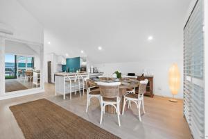 a kitchen and dining room with a table and chairs at Ocean View Villa, 2 bedroom in Mandurah