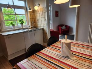 a kitchen and dining room with a table with chairs and a table sidx sidx sidx at City Breakaway in Sønderborg