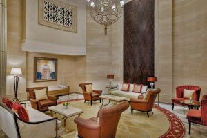 a lobby of a hotel with furniture and a chandelier at The St. Regis Abu Dhabi in Abu Dhabi