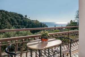 a table on a balcony with a view of the ocean at Diov Bohali House in Zakynthos Town
