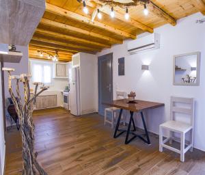 a kitchen and dining room with a table and chairs at Bonzoe #4 in Parikia +25 photos