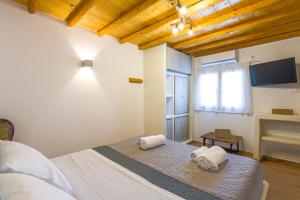 a bedroom with a bed with towels on it at Bonzoe #4 in Parikia