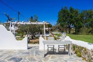 a patio with a white table and chairs at Bonzoe #4 in Parikia