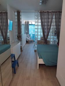 a room with two beds and a mirror at BLU in Puerto del Carmen