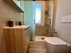 a bathroom with a shower and a toilet and a sink at Condominio Sporting in Lignano Sabbiadoro