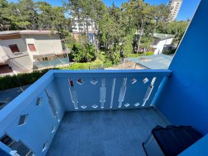 a view from the balcony of a apartment with blue walls at Condominio Sporting in Lignano Sabbiadoro +4 photos