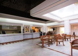 a dining room with tables and chairs and a bar at Modern studio with swimming pool in Lowlands - 68 m² in Lowlands