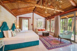 a bedroom with a large bed and a couch at Layla Gocek Adults only in Göcek +37 photos