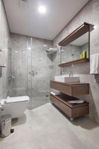 a bathroom with a shower and a toilet and a sink at RETRO 9 HOMES & SUITES ISTANBUL in Istanbul