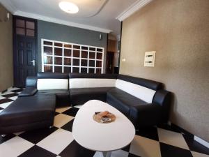 a living room with a couch and a table at Agbata Guest House 