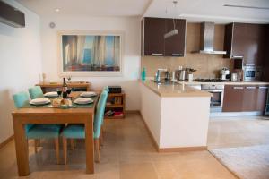 a kitchen with a wooden table and a dining room at 1 Bed Boutique-style Apartment in São Martinho do Porto
