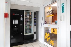 a vending machine in a store next to a window at Premiere Classe Meaux Nanteuil Les Meaux in Nanteuil-l&egrave;s-Meaux
