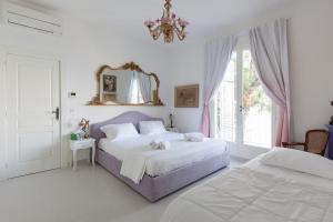 a bedroom with two beds and a mirror on the wall at Château des Anglais - Five Stars Holiday House in Nice