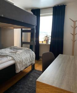 a bedroom with a bunk bed and a table at Brinkeboda Wärdshus in Mörsil