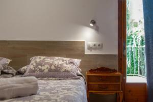 a bedroom with a bed and a nightstand and a window at Blanch 1 in Tremp
