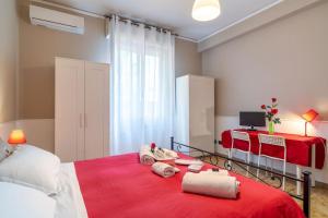 a bedroom with two beds and a red blanket at Terrazze Italiane City Center - RED APARTMENT in Verona