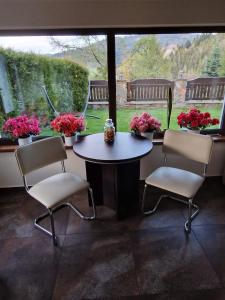 a table and chairs in a room with a window at Irena in Korbielów