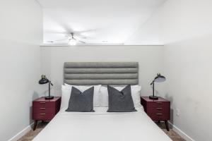 a bedroom with a white bed with two night stands at CozySuites MusicRow Astonishing Studio with free parking 52 in Nashville