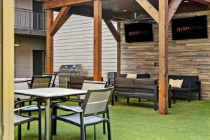a group of tables and chairs on a patio at CozySuites MusicRow Astonishing Studio with free parking 52 in Nashville