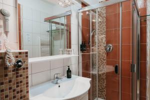 a bathroom with a sink and a shower at OREA Resort Panorama Moravský kras in Blansko