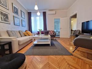 a living room with a couch and a table at Urban Downtown Apartment in Belgrade