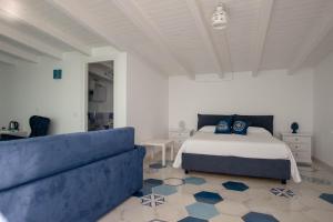 um quarto com uma cama e um sofá em B&B Mammaliturchi SCALA DEI TURCHI em Realmonte