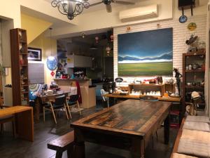 a room with a table and a large painting on the wall at Ninth Great-uncle in Longtian