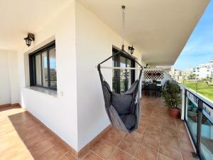a hammock on the balcony of a house at Puerta del Cabo in Retamar