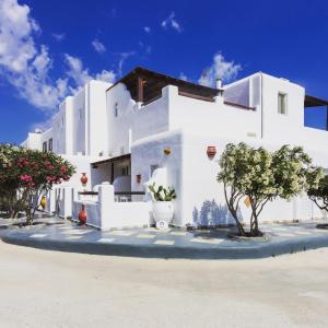 a white house with trees in front of it at Irene's Residence in Mikonos
