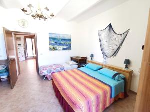 a bedroom with a bed and a mirror at Le Frasche di Marido holiday apartments in Alberese