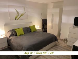 a bedroom with a bed with two lime green pillows at Schwarzwaldblick in Schonwald im Schwarzwald