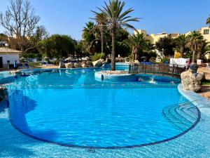a large pool with blue water in a resort at Apartamentos Moguima in Roquetas de Mar