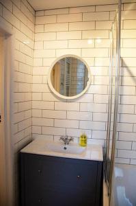 a bathroom with a sink and a mirror at Lovely cottage with private garden in Penryn