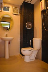 a bathroom with a toilet and a sink and a mirror at Royal Express Inn in Bangkok +20 photos