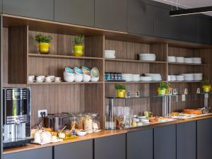 a kitchen with a counter with plates and dishes at Hotel Villa Rosetta in Umag